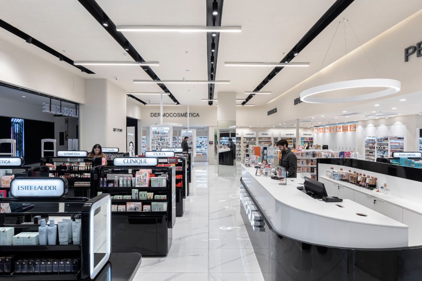 San Roque Pharmacy - Modern retail aisle featuring perfumery section and LED linear lighting - Contract Workplaces.jpg